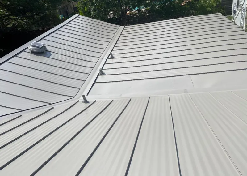 Solar attic fan installed on a metal roof for Roof Ventilation in Osceola